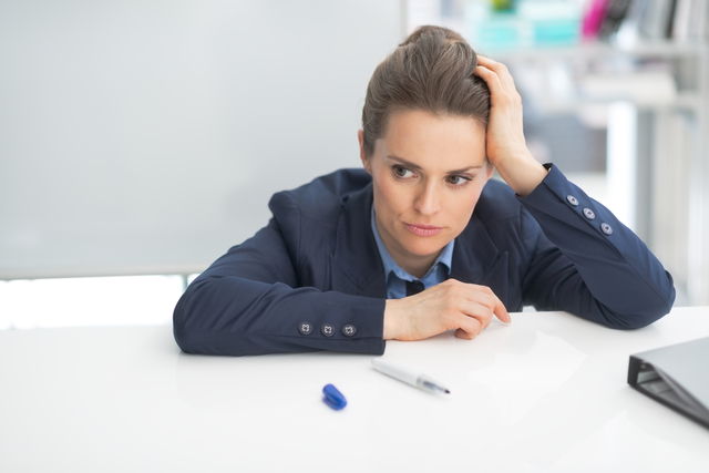 Stressed business woman near flipchart